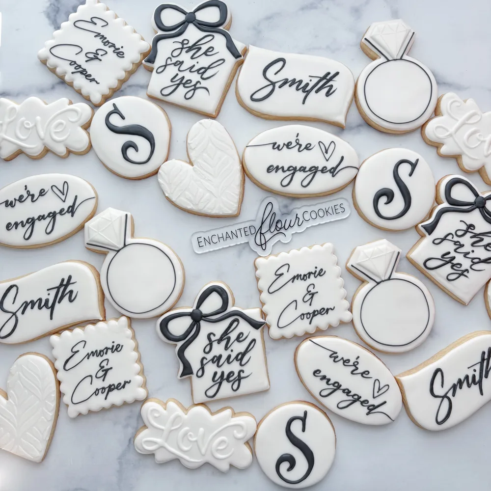 Simple tier example: Black and white she said yes engagement cookie set